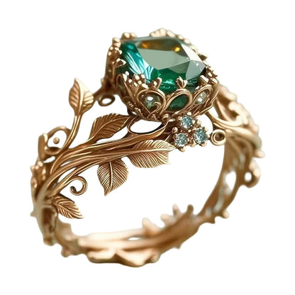 Ring mit grünem synthetischem Kristall und filigranem Blattdesign